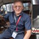Sobiesław Zasada, kierowca rajdowy i biznesmen oraz okładka jego książki sprzed lat "Prędkość bezpieczna". Fot Jzdzarski - Praca własna, CC BY-SA 4.0/arch. pryw.